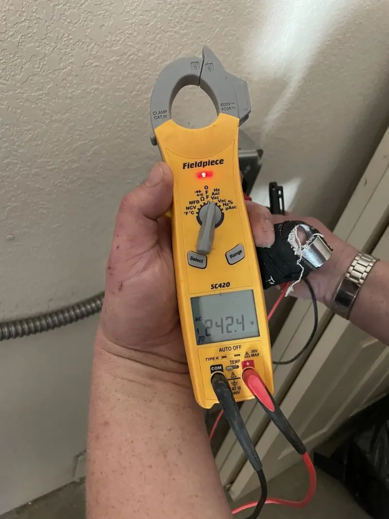 Voltage testing with clamp meter during Recessed Lighting Installation in Barbecue
